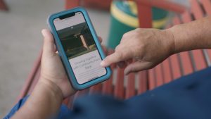 A young person using the Community Point Bank mobile banking app